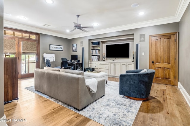 living room featuring ceiling fan, ornamental molding, and light wood-type flooring