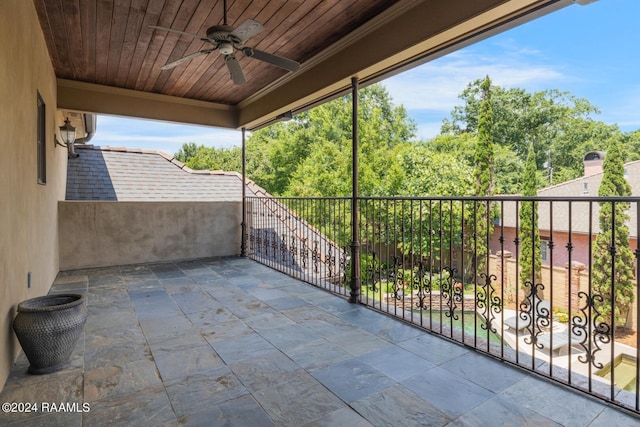 view of patio featuring ceiling fan and a balcony