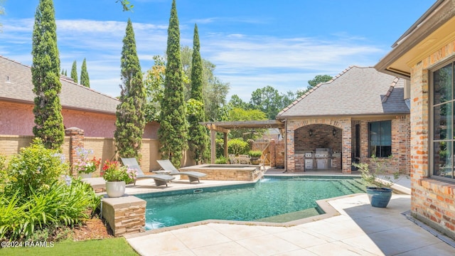 view of pool featuring an in ground hot tub, pool water feature, a patio, and area for grilling