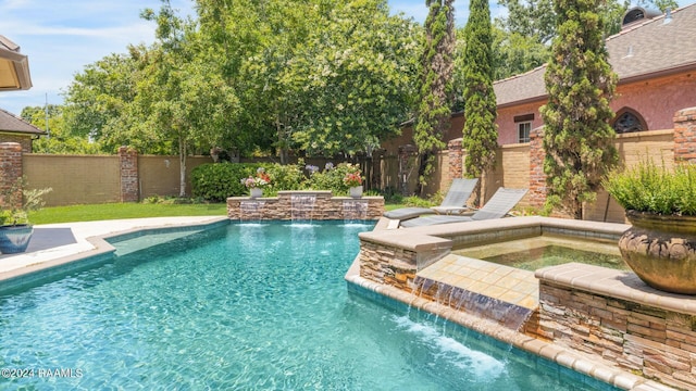 view of pool with an in ground hot tub and pool water feature