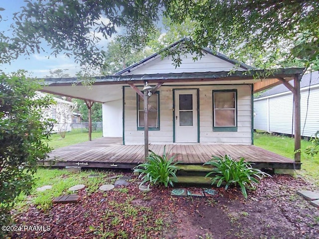 rear view of property with covered porch