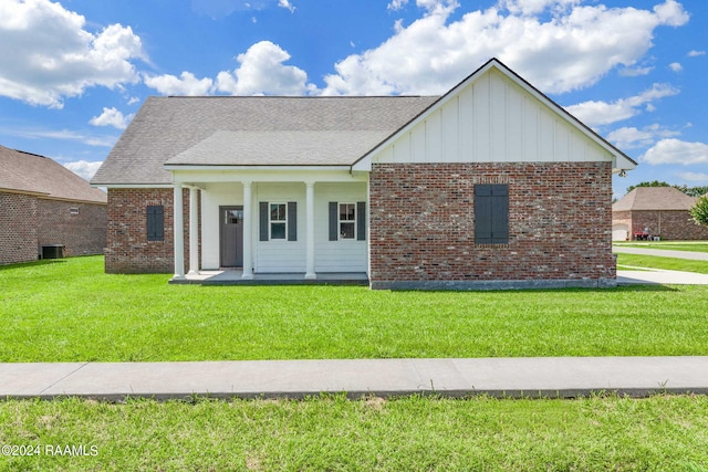 view of front of property with a porch and a front yard