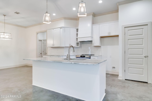 kitchen featuring white cabinetry, a kitchen island with sink, and decorative light fixtures