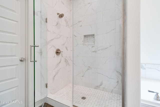 bathroom with a shower with door