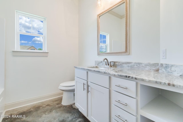 bathroom featuring vanity, toilet, and concrete flooring