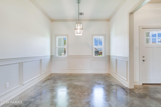 unfurnished dining area with concrete floors and crown molding