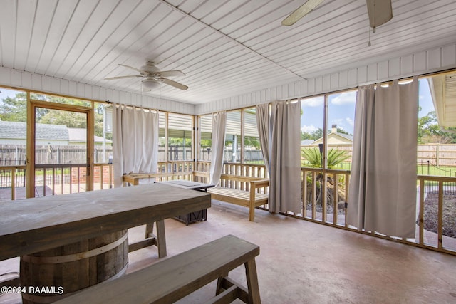 sunroom / solarium with plenty of natural light and ceiling fan