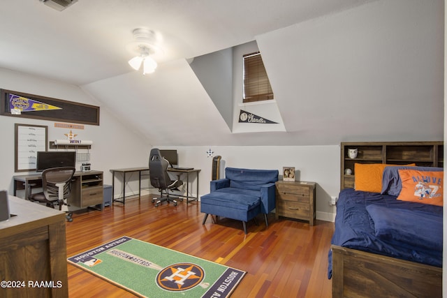 bedroom featuring hardwood / wood-style floors and vaulted ceiling