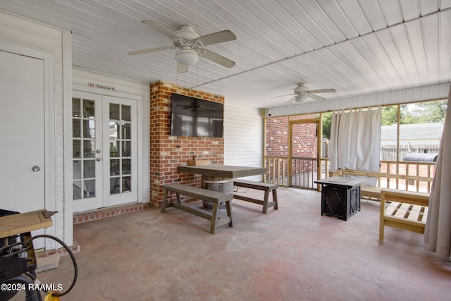 sunroom featuring french doors and ceiling fan