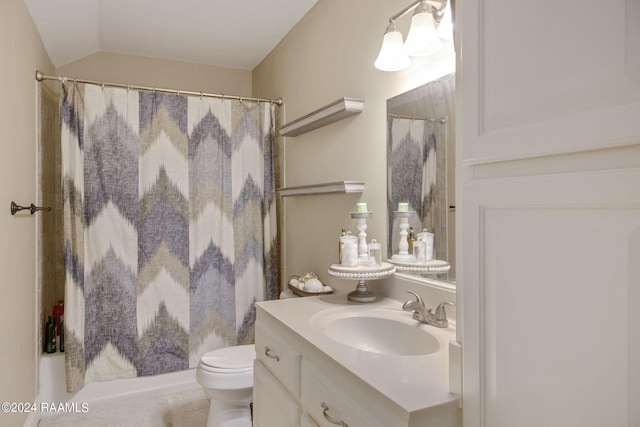 bathroom with vanity, vaulted ceiling, and toilet