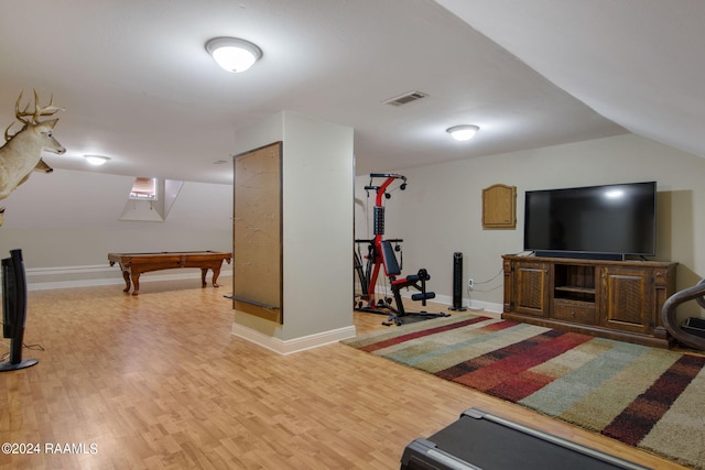 exercise room featuring billiards, lofted ceiling, and light hardwood / wood-style floors