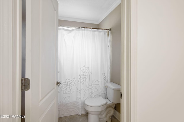 bathroom featuring ornamental molding and toilet