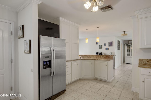 kitchen featuring light tile patterned floors, stainless steel refrigerator with ice dispenser, hanging light fixtures, and kitchen peninsula