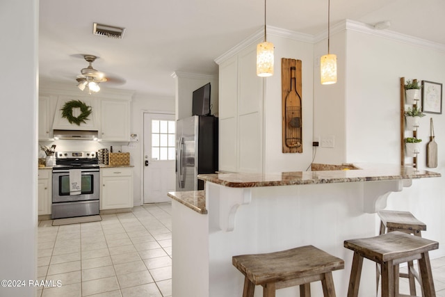 kitchen with light tile patterned floors, light stone counters, stainless steel fridge, ceiling fan, and range with electric cooktop