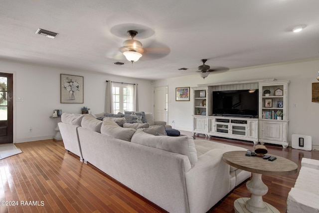 living room featuring ceiling fan and wood-type flooring