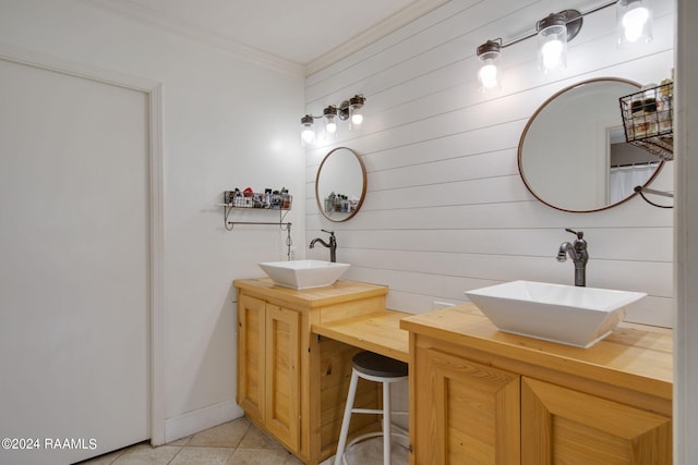 bathroom featuring dual bowl vanity, crown molding, and tile patterned floors