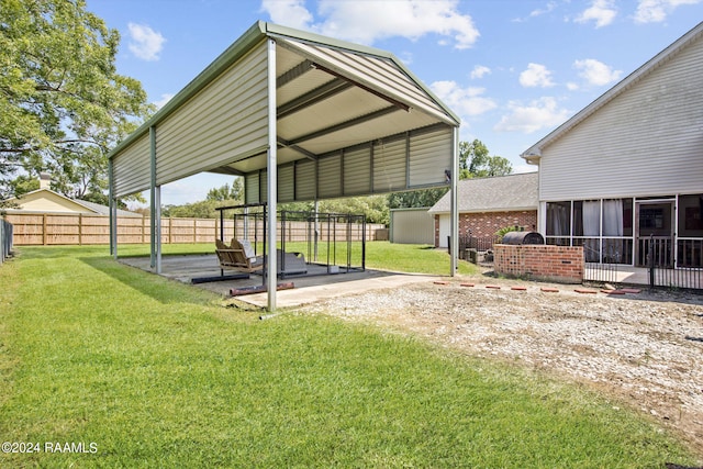 view of yard featuring a sunroom and a carport