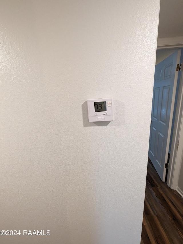 room details featuring a textured wall and wood finished floors