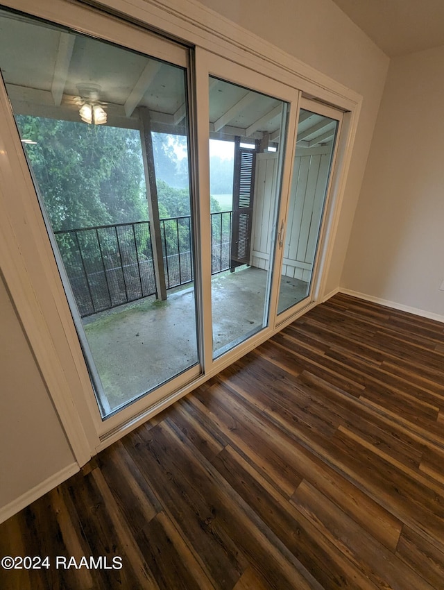 interior space with dark wood-type flooring, baseboards, and a ceiling fan