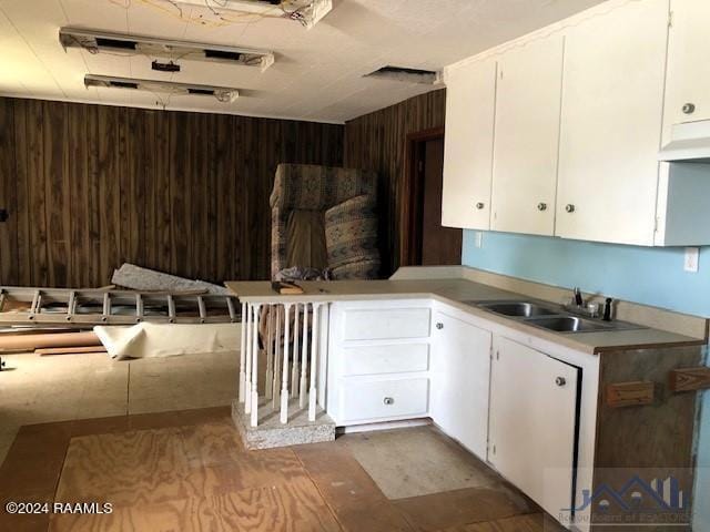 kitchen with exhaust hood, sink, and white cabinets