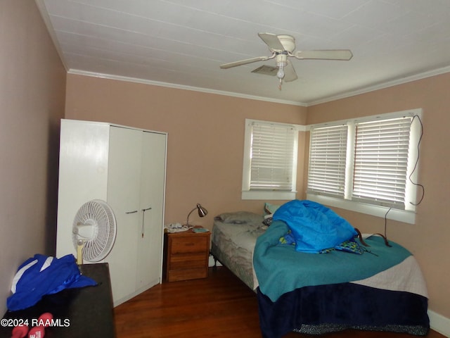 bedroom featuring ceiling fan, dark hardwood / wood-style flooring, and ornamental molding