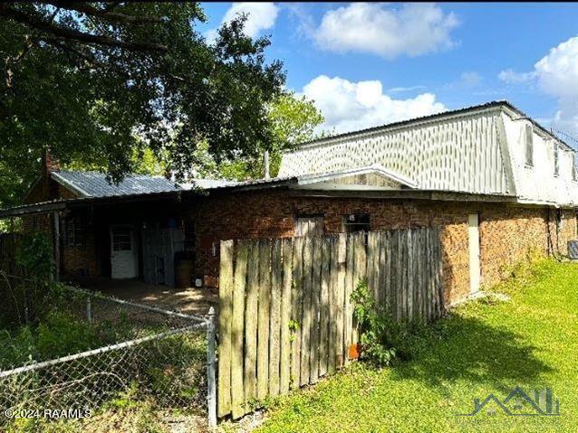 view of home's exterior with a lawn