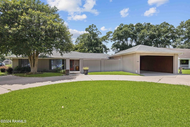 ranch-style home with a garage and a front yard