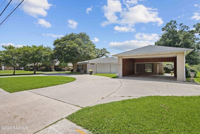 4901 N University Ave, Carencro, LA 70520 - view of side of property with curved driveway, a yard, a shingled roof, and an attached carport
