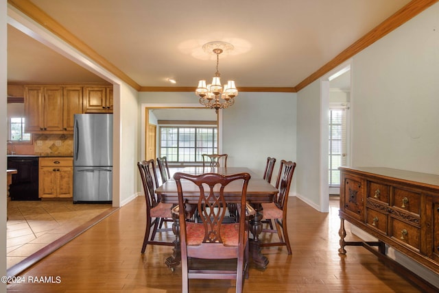 dining area featuring a chandelier, light hardwood / wood-style flooring, and a healthy amount of sunlight