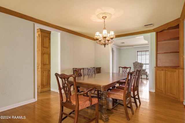 dining space featuring wood-type flooring, an inviting chandelier, and ornamental molding