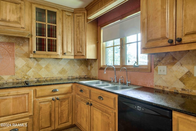 kitchen featuring dishwasher, sink, dark stone counters, and tasteful backsplash