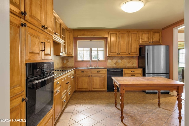 kitchen featuring decorative backsplash, sink, light tile patterned floors, and black appliances