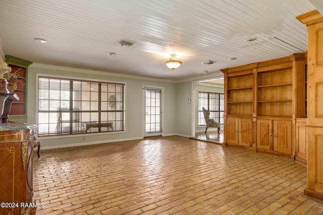 unfurnished living room featuring ornamental molding