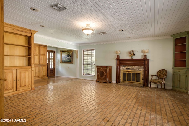 unfurnished living room with wooden ceiling and a brick fireplace