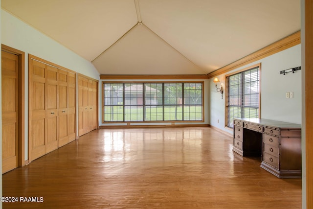 interior space with light hardwood / wood-style flooring and lofted ceiling