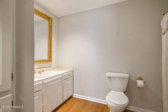 4901 N University Ave, Carencro, LA 70520 - bathroom with wood finished floors, vanity, and ornamental molding