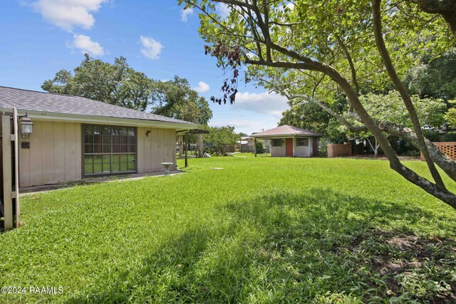 4901 N University Ave, Carencro, LA 70520 - view of grassy yard featuring an outbuilding