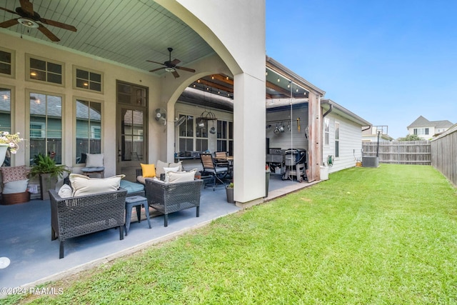 view of yard with a patio area, ceiling fan, cooling unit, and an outdoor living space