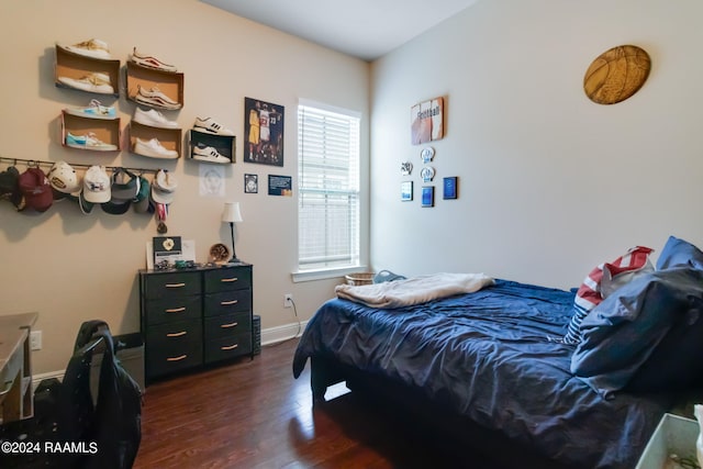 bedroom with dark wood-type flooring