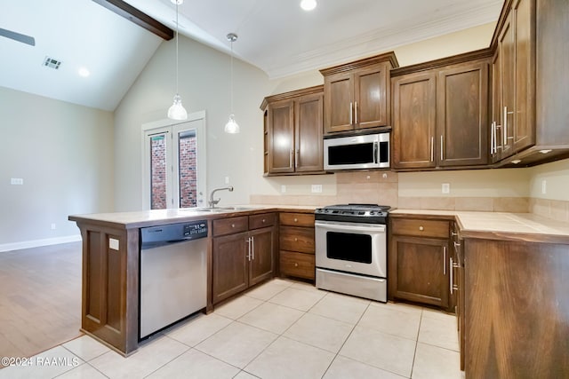 kitchen with stainless steel appliances, sink, light tile patterned floors, decorative light fixtures, and vaulted ceiling with beams