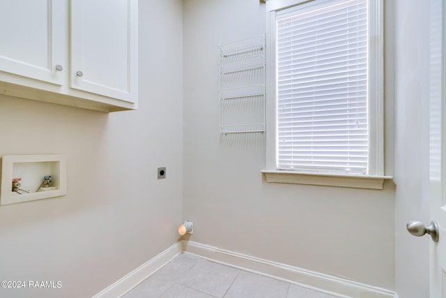 laundry area featuring hookup for a washing machine, light tile patterned flooring, cabinets, and hookup for an electric dryer