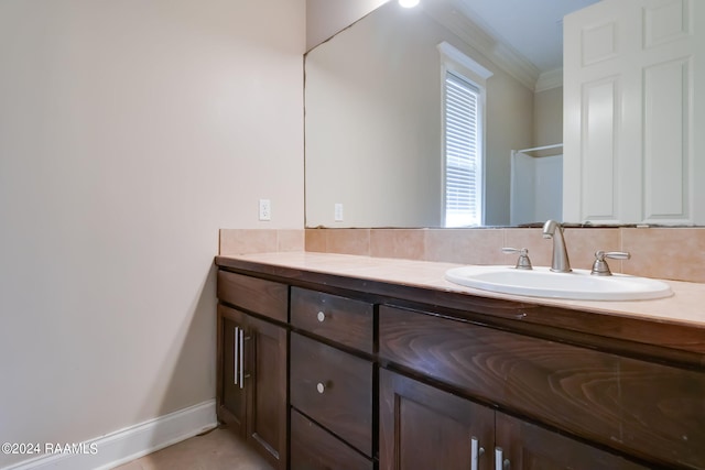 bathroom with tile patterned floors, vanity, and ornamental molding