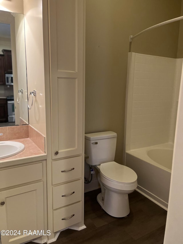 full bathroom featuring wood-type flooring, vanity, toilet, and  shower combination