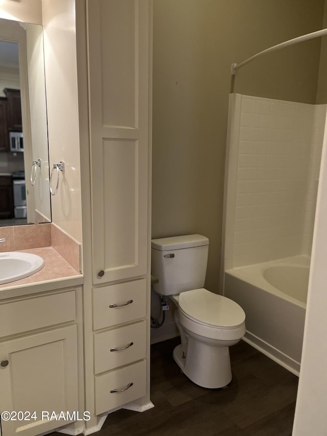 117 Seaside Ln, Lafayette, LA 70506 - bathroom with toilet, wood finished floors, vanity, and washtub / shower combination