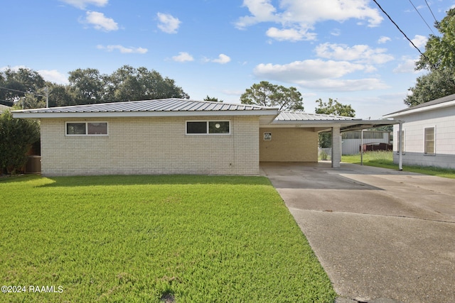 view of front of property with a carport and a front lawn