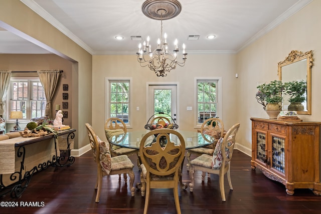 dining area with dark hardwood / wood-style floors, ornamental molding, and an inviting chandelier