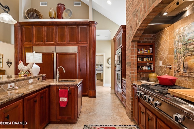 kitchen with appliances with stainless steel finishes, tasteful backsplash, decorative light fixtures, and lofted ceiling