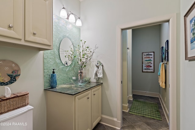 bathroom featuring decorative backsplash, vanity, and tile patterned flooring