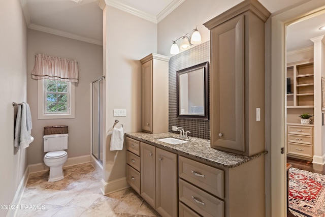 bathroom featuring crown molding, vanity, an enclosed shower, and toilet