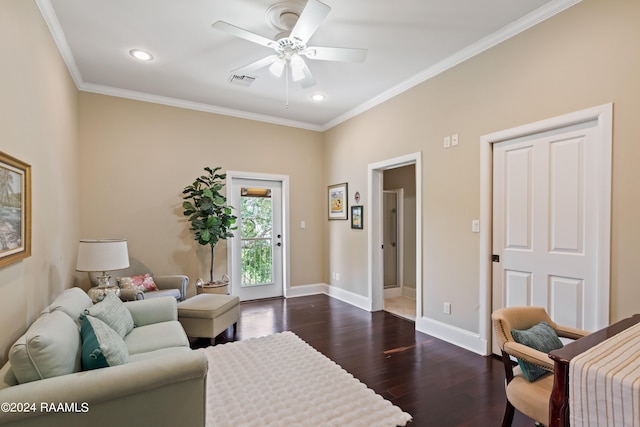 living room with dark hardwood / wood-style flooring, ceiling fan, and crown molding